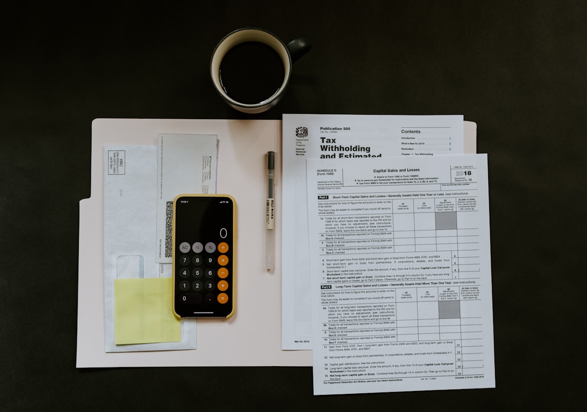 Person reviewing a financial application and household budget at a desk